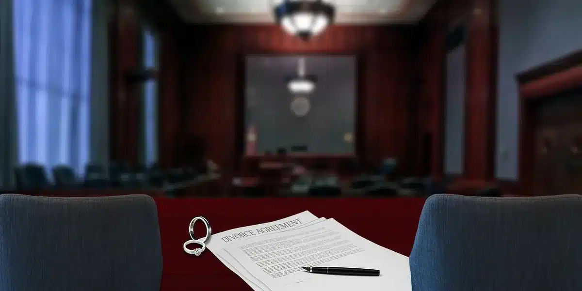 Stack of legal filings and a courtroom gavel on a table