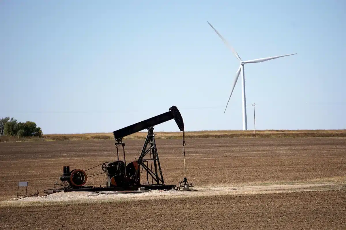 Workers at an oil well site preparing equipment to restart a dormant well