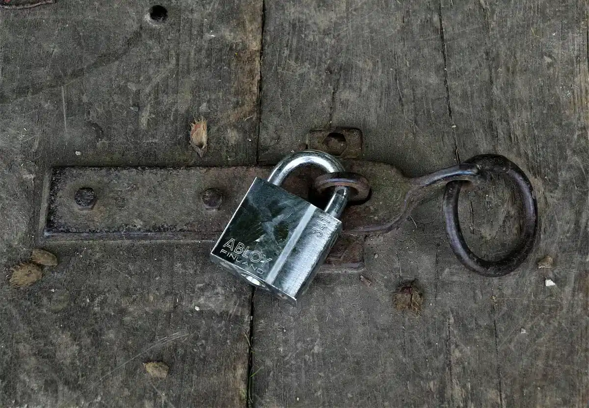 A home door with modern locks and a notice about safety