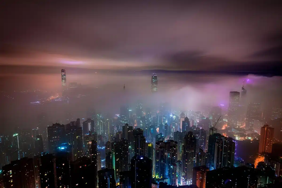 Low moon above a quiet city skyline suggesting order and routine