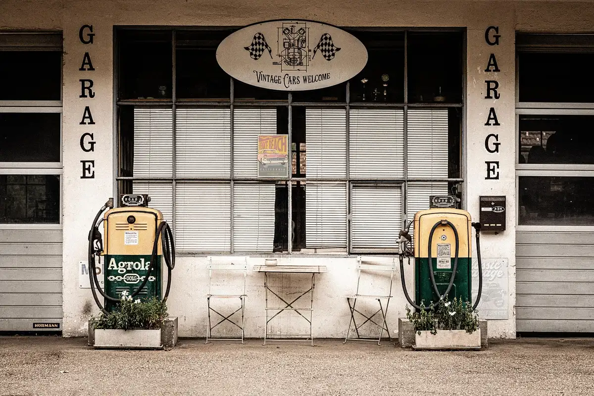 Drivers filling up at a supermarket gas station with multiple pumps