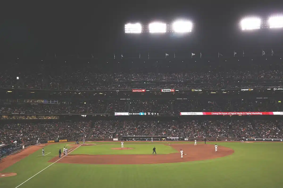 Batter watching a two-run home run sail toward the outfield