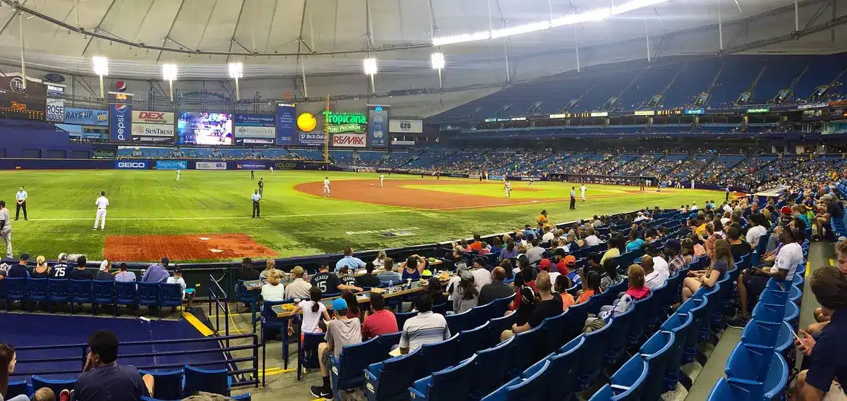 Empty ballpark concourse with gloves and scoreboard in the distance